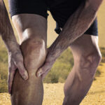 A cropped shot of a man holding his knee because of a defective orthopedic implant