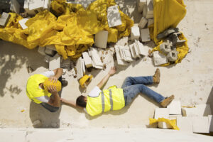 A man lying on the ground after a workplace accident in Atlanta
